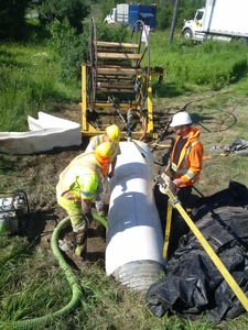 Crew installing pipe liner